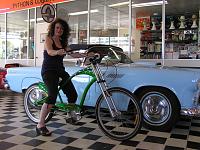 Maggie on her beach cruzer with her 56' T-bird in the back ground in the Python showroom in Melbourne Australia