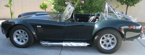 Side. Pic is from the Ebay listing. Those hokey side pipe guards are gone and replaced with plain stainless. Missing spinner has been replaced, windshield racked back as far as I could get it, and the roll bar is gone.