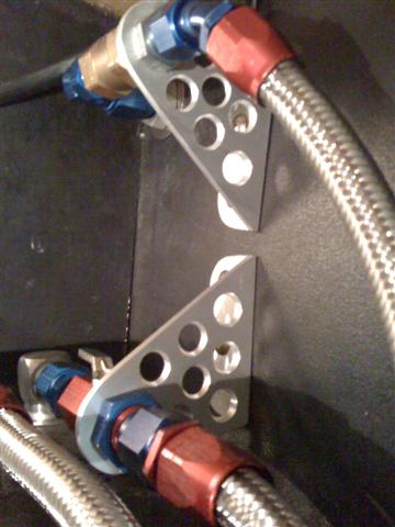 Custom support brackets for hoses including hidden fuel shutoff valve.