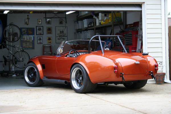 Custom-molded E-M body:  Body lower by 1-1/2" at rear of tub.  Rear fender/trunk section re-shaped to be 3" lower at tailights.  Standard E-M from rear bulkhead foreward. Hand-laid extra light.