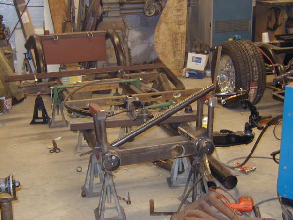 The chassis began as two lengths of 4" steel tubing on jack stands.  All parts were cut out by hand, assembled and hand welded to form the completed chassis.