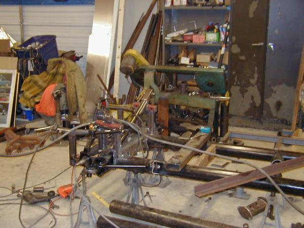 The chassis began as two lengths of 4" steel tubing on jack stands.  All parts were cut out by hand, assembled and hand welded to form the completed chassis.