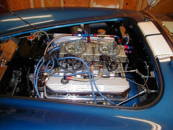 351W motor with my FE valve cover adapter kit, cast aluminum FE valve covers, and a home made dual quad intake modified from the Offenhouser single plane intake manifold.